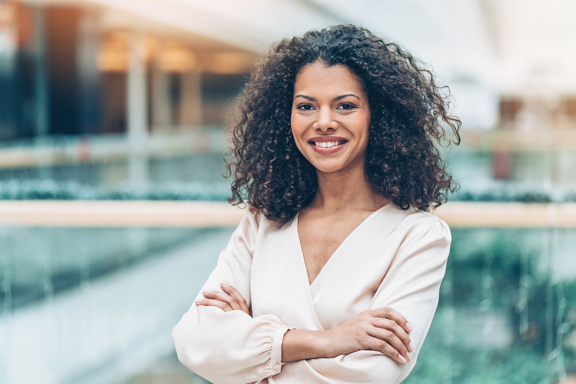 Woman-smiling-with-arms-folded